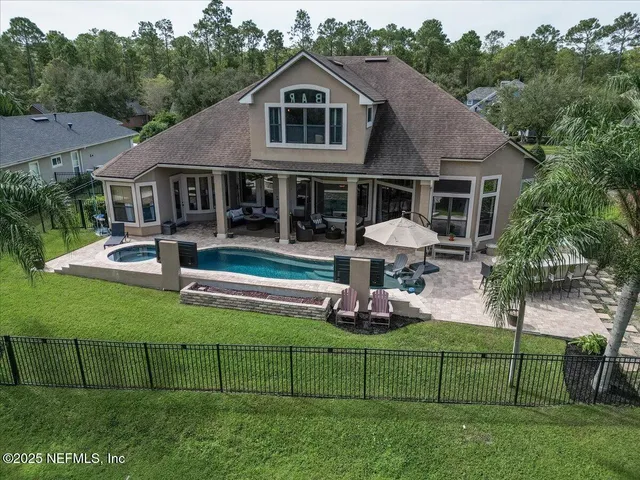 a view of a hallway with wooden floor and a mirror