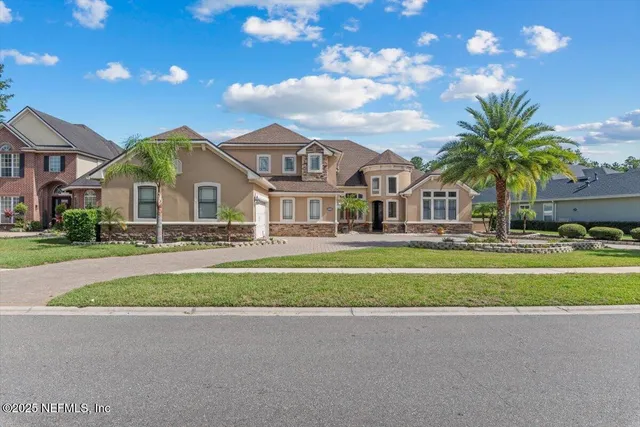 a kitchen with kitchen island granite countertop a sink stove and cabinets