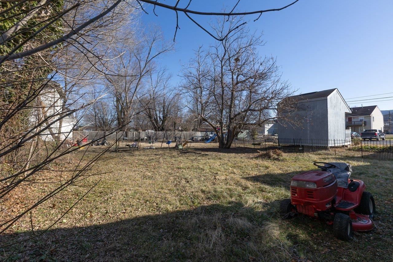 317 West 12th Street Waynesboro, VA 22980 - Photo 36 of 39 a view of a backyard with table and chairs under an umbrella