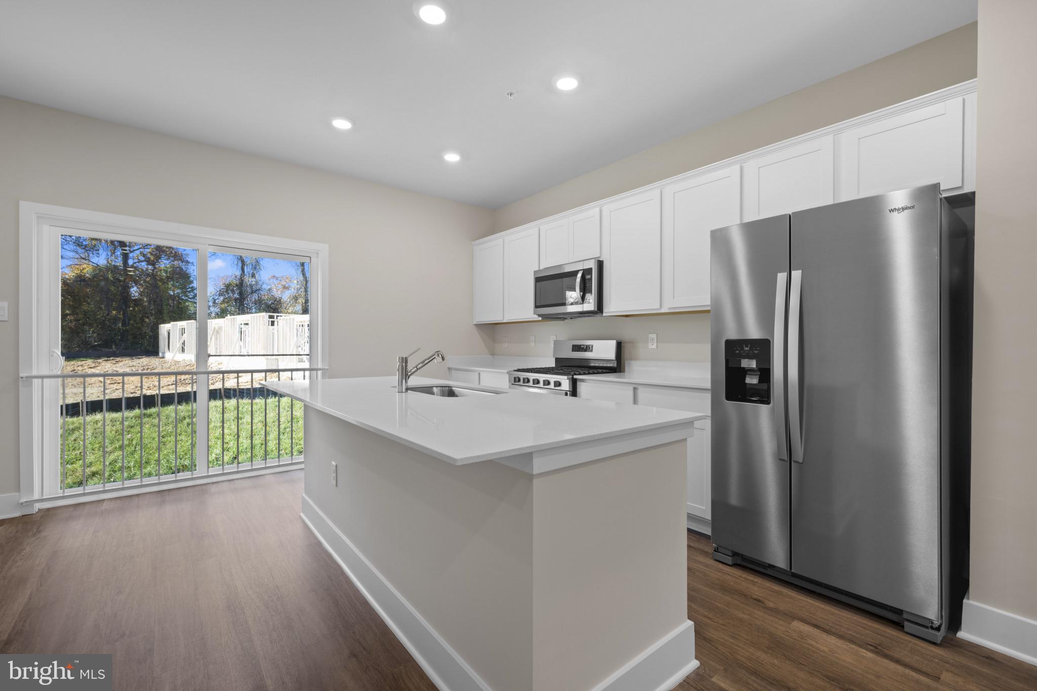 355 Hackley Drive Joppa, MD 21085 - Photo 15 of 38 a kitchen with kitchen island a refrigerator sink and stove