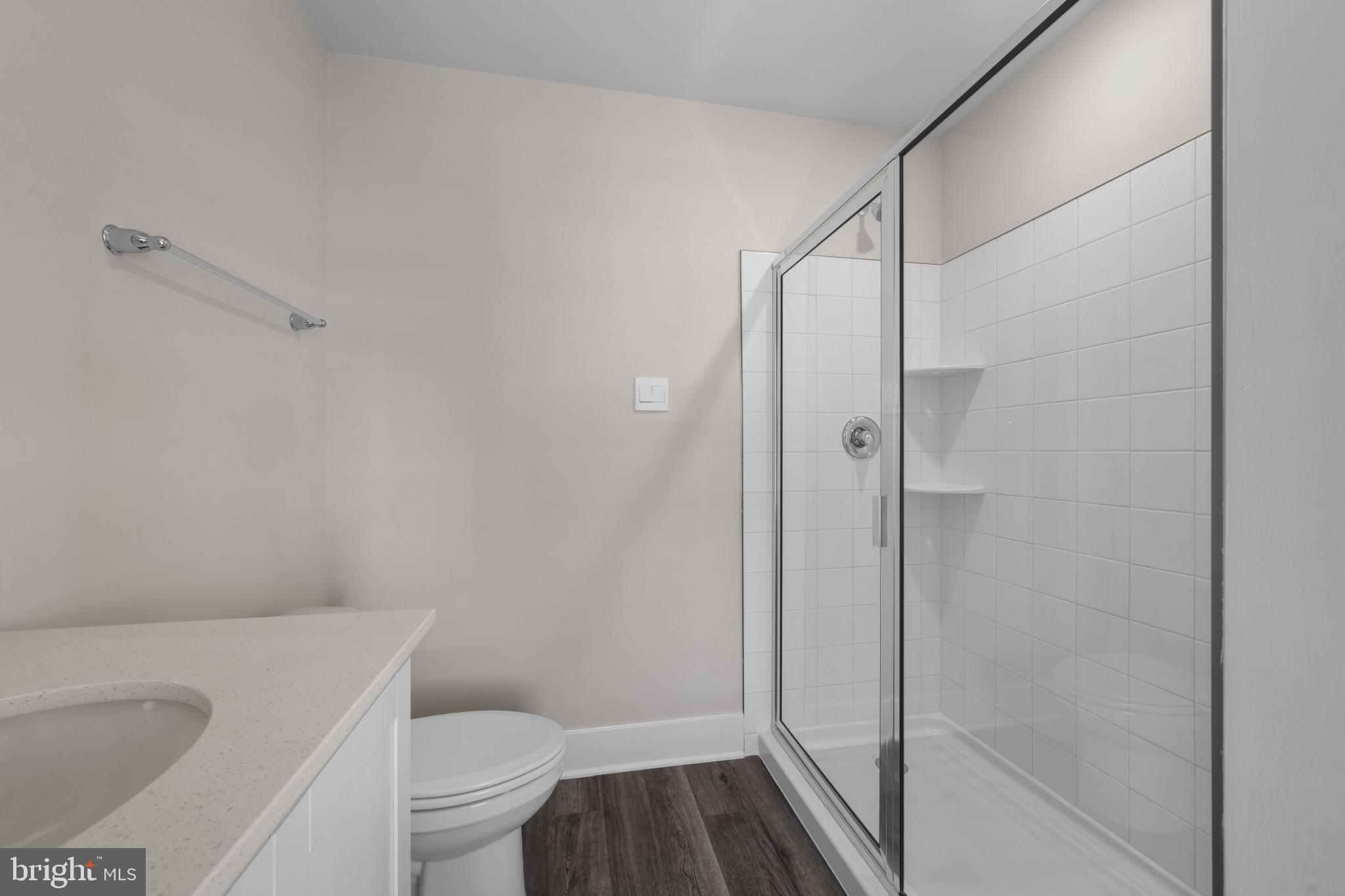 355 Hackley Drive Joppa, MD 21085 - Photo 23 of 38 a bathroom with a granite countertop toilet and a shower