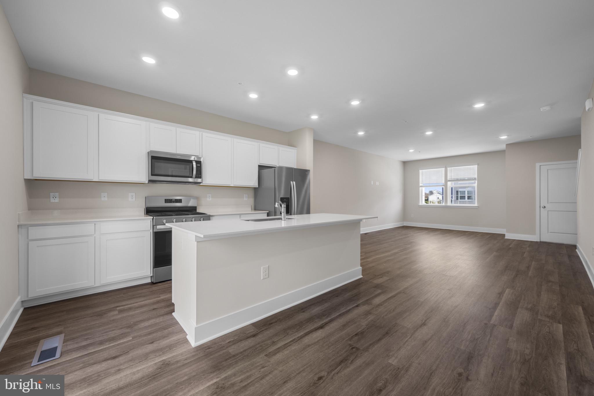355 Hackley Drive Joppa, MD 21085 - Photo 10 of 38 a large kitchen with cabinets wooden floor and stainless steel appliances