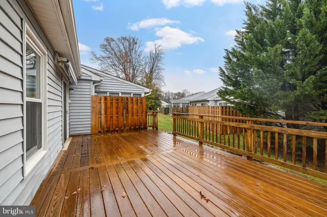 a view of balcony with wooden floor and fence