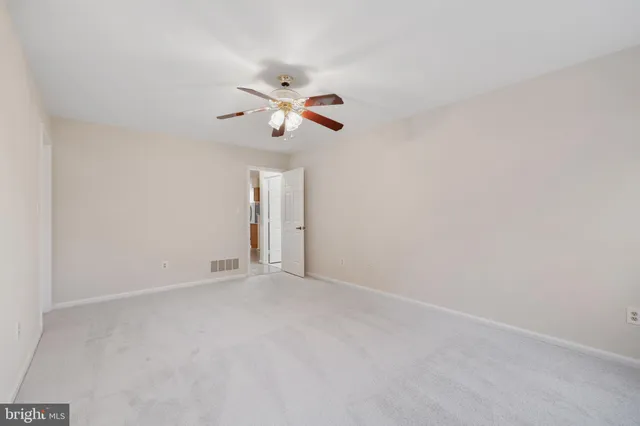 a view of an empty room with a fan