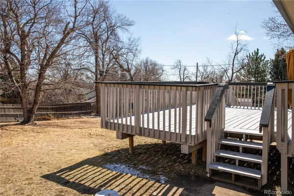 a view of a roof deck with wooden floor and fence