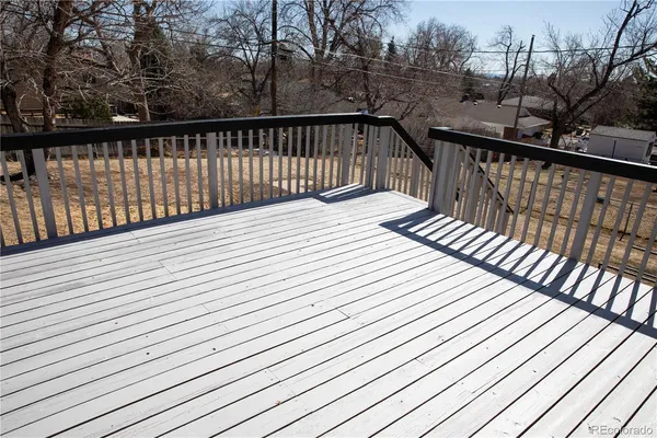 a balcony with wooden floor and fence