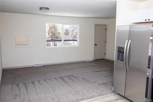 a view of an empty room with a window