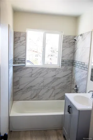 a bathroom with a bathtub and a sink