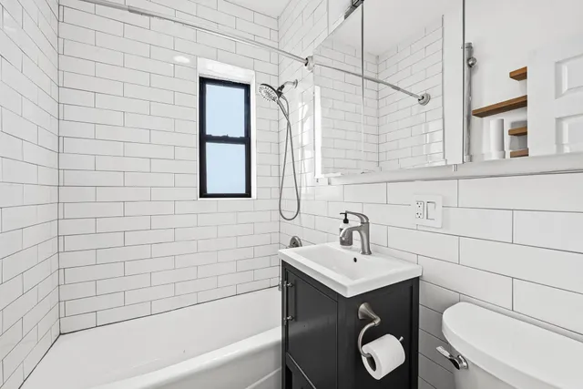 a bathroom with a sink a toilet and bathtub