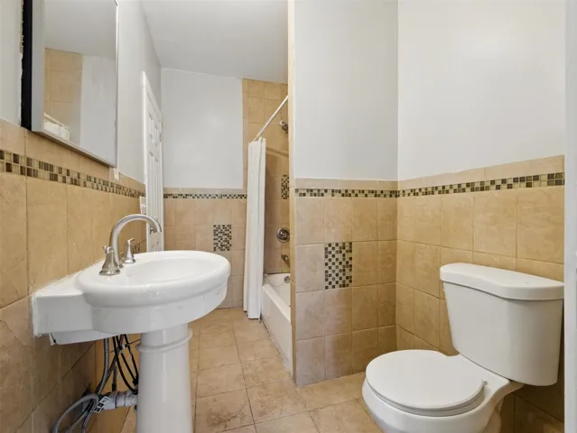 a bathroom with a sink mirror toilet and shower