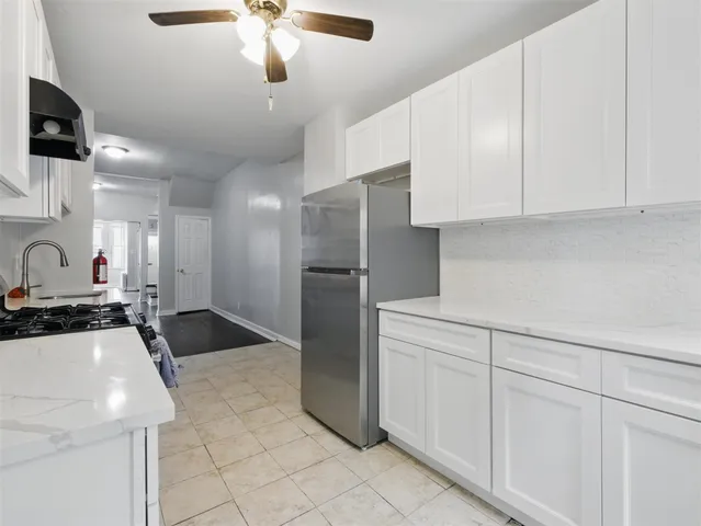 a kitchen with stainless steel appliances granite countertop a sink and a refrigerator