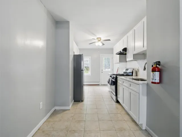 a large kitchen with cabinets and stainless steel appliances