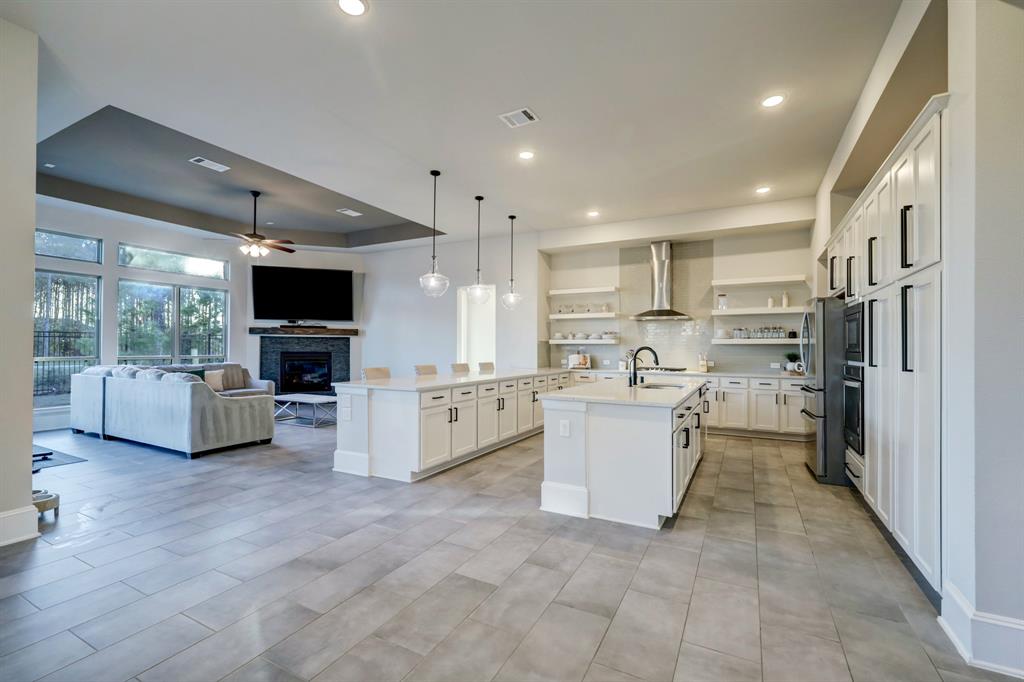 a view of kitchen with stainless steel appliances kitchen island granite countertop a stove and a sink