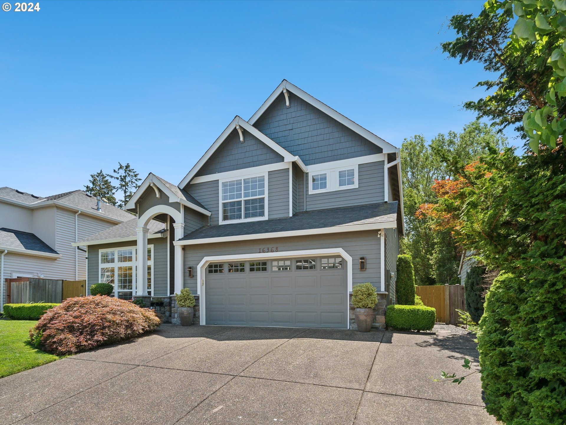 16368 Northwest Graf Street Portland, OR 97229 - Photo 12 of 46 a front view of a house with a garden and garage