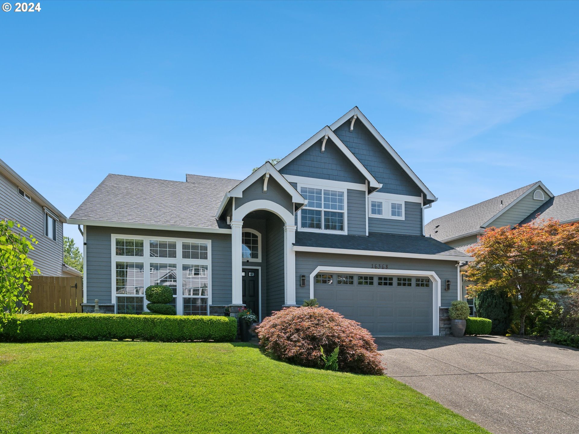 16368 Northwest Graf Street Portland, OR 97229 - Photo 14 of 46 a front view of a house with a garden and yard