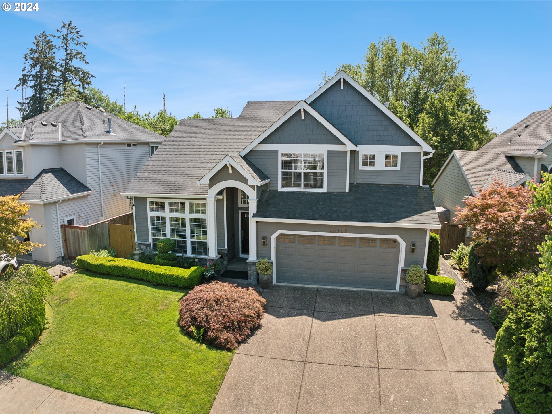 16368 Northwest Graf Street Portland, OR 97229 - Photo 15 of 46 a front view of a house with a yard and garage