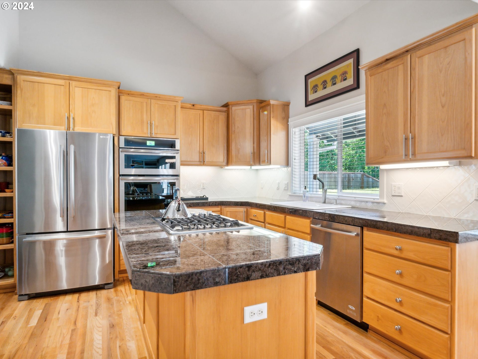 16368 Northwest Graf Street Portland, OR 97229 - Photo 22 of 46 a kitchen with stainless steel appliances granite countertop a refrigerator a sink and a stove with wooden floor