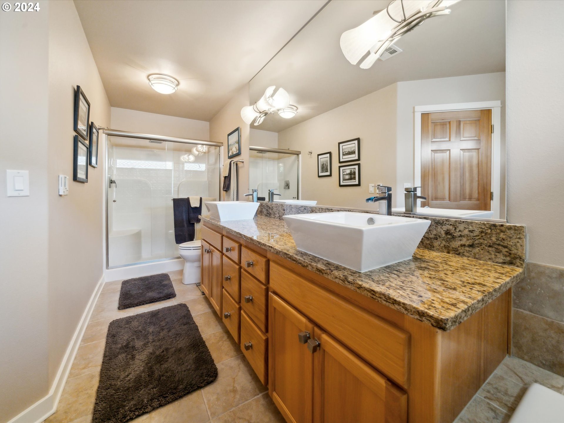 16368 Northwest Graf Street Portland, OR 97229 - Photo 30 of 46 a spacious bathroom with a granite countertop sink a mirror and shower