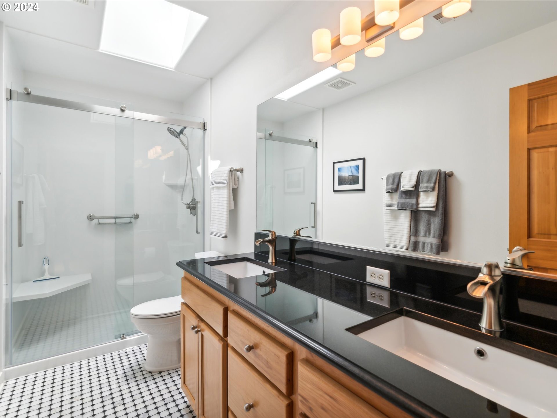 16368 Northwest Graf Street Portland, OR 97229 - Photo 33 of 46 a bathroom with a sink a toilet a mirror and shower