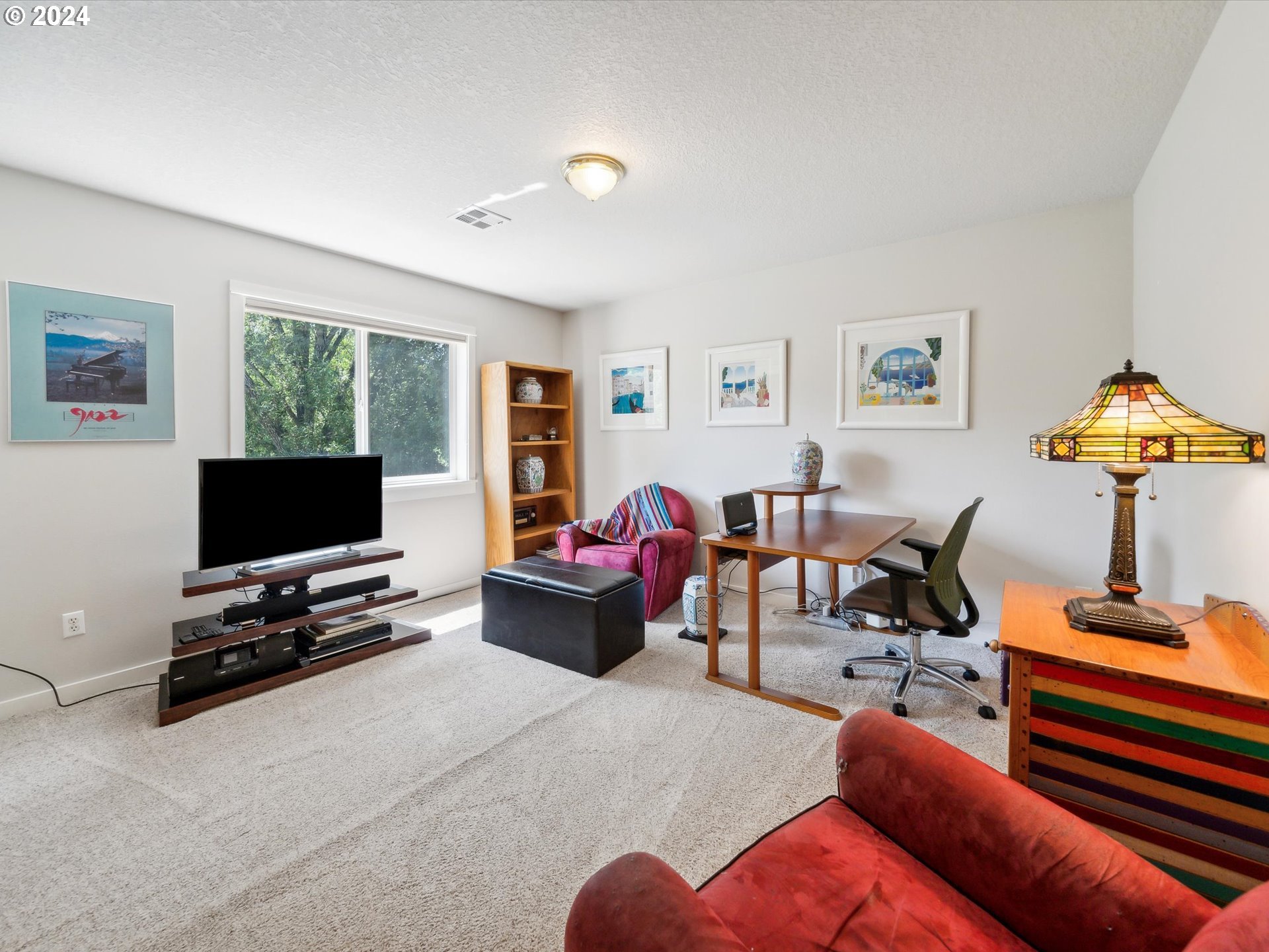 16368 Northwest Graf Street Portland, OR 97229 - Photo 34 of 46 a living room with furniture and a flat screen tv