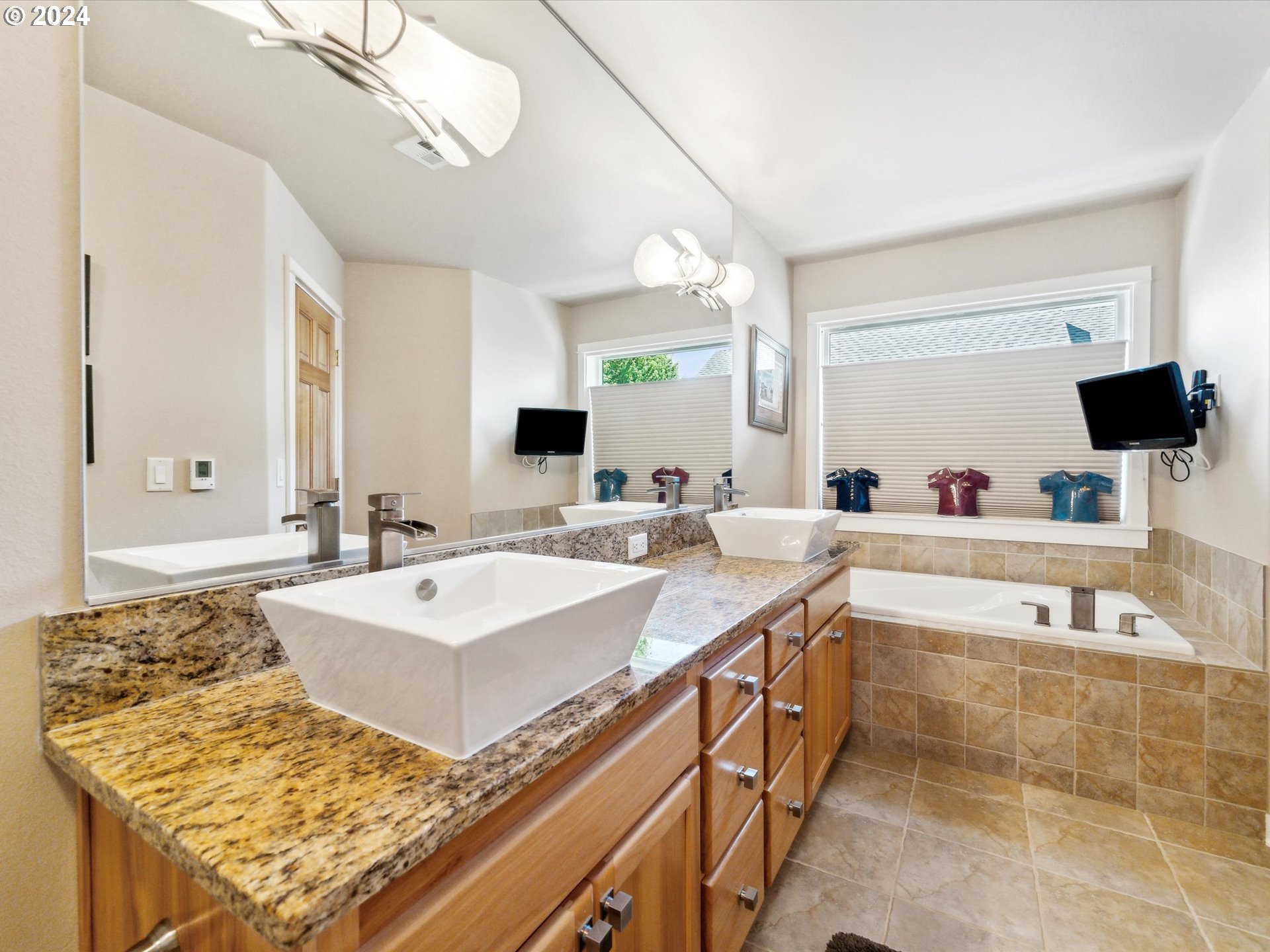 16368 Northwest Graf Street Portland, OR 97229 - Photo 7 of 46 a bathroom with a tub sink and mirror