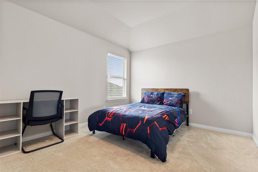 2304 Ravensway Road Crandall, TX 75114 - Photo 11 of 22 a bedroom with a bed chair and window