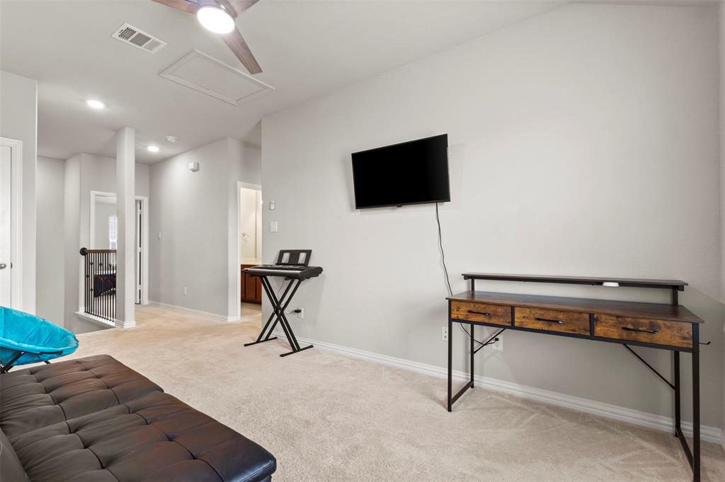 2304 Ravensway Road Crandall, TX 75114 - Photo 12 of 22 a living room with furniture and a flat screen tv