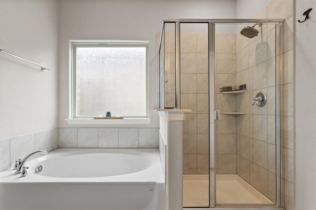 2304 Ravensway Road Crandall, TX 75114 - Photo 13 of 22 a bathroom with a bathtub and a shower