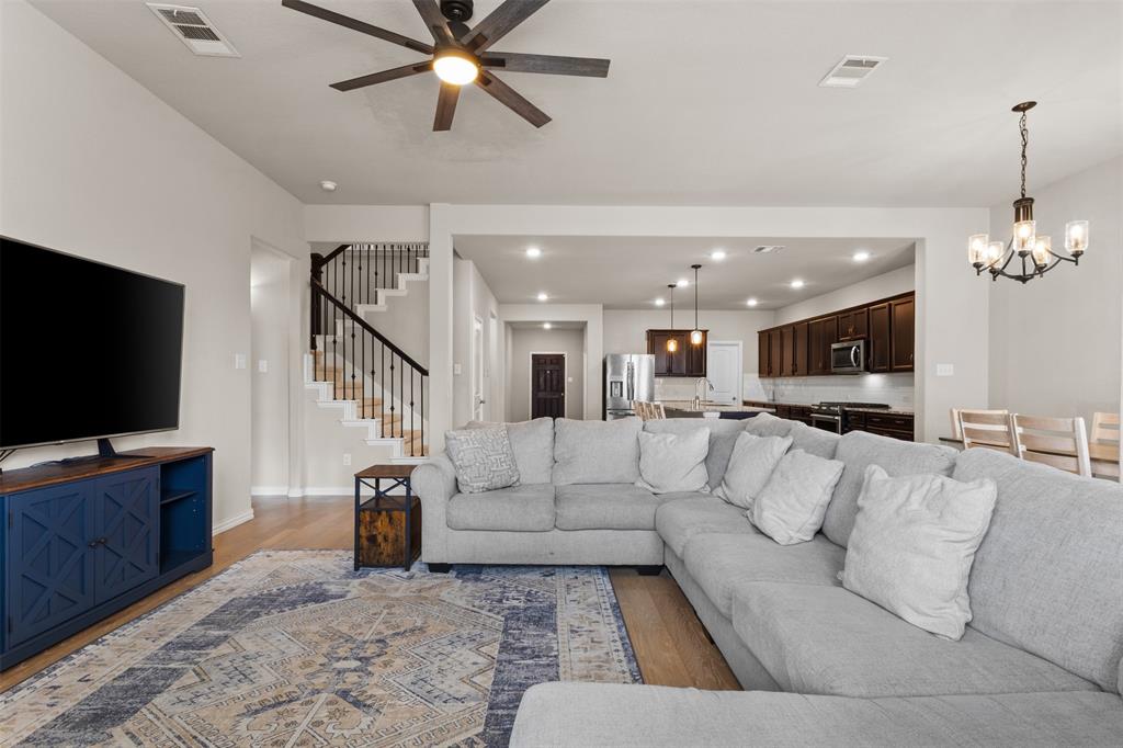 2304 Ravensway Road Crandall, TX 75114 - Photo 16 of 22 a living room with furniture and a flat screen tv