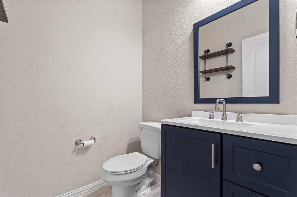 2304 Ravensway Road Crandall, TX 75114 - Photo 19 of 22 a bathroom with a toilet sink and mirror