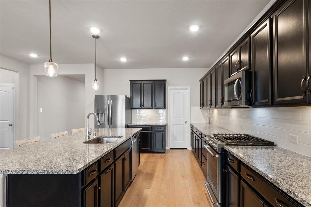 2304 Ravensway Road Crandall, TX 75114 - Photo 4 of 22 a kitchen with granite countertop stainless steel appliances lots of counter top space