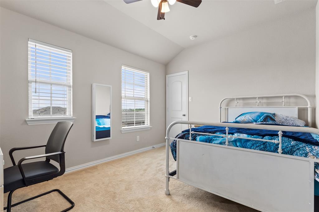 2304 Ravensway Road Crandall, TX 75114 - Photo 9 of 22 a bed sitting in a bedroom next to a window