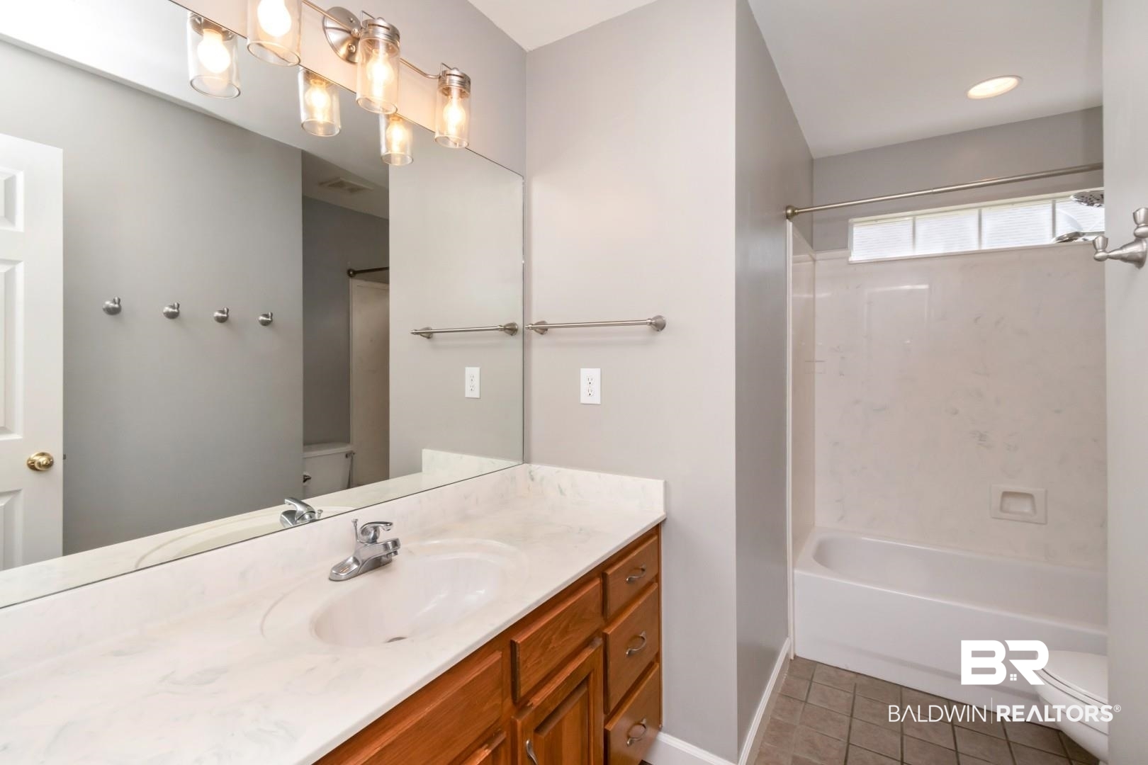 10691 Hunters Ridge Drive Mobile, AL 36695 - Photo 21 of 37 Bathroom featuring a wood-finish vanity with a single sink, light-colored countertop, and chrome faucet