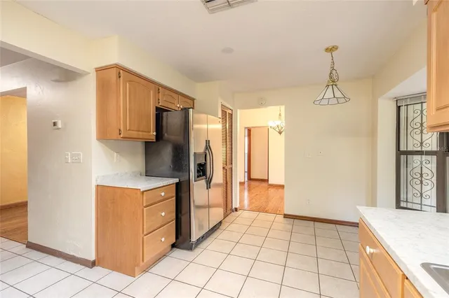 a kitchen with stainless steel appliances granite countertop a refrigerator a stove and a sink with granite countertops