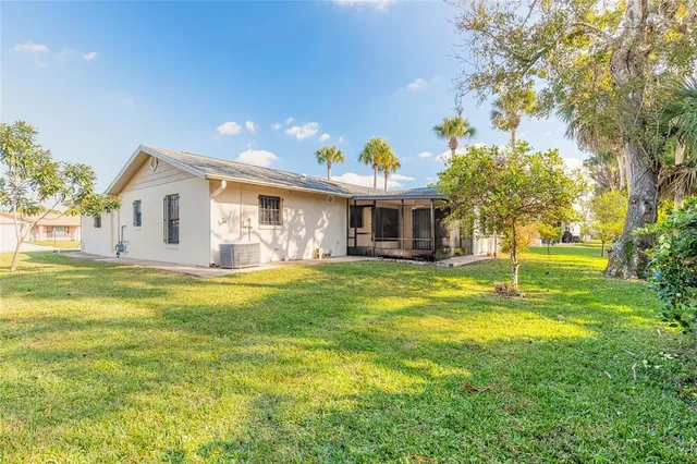 a front view of house with yard and swimming pool