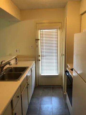 a kitchen with a sink a window and stainless steel appliances