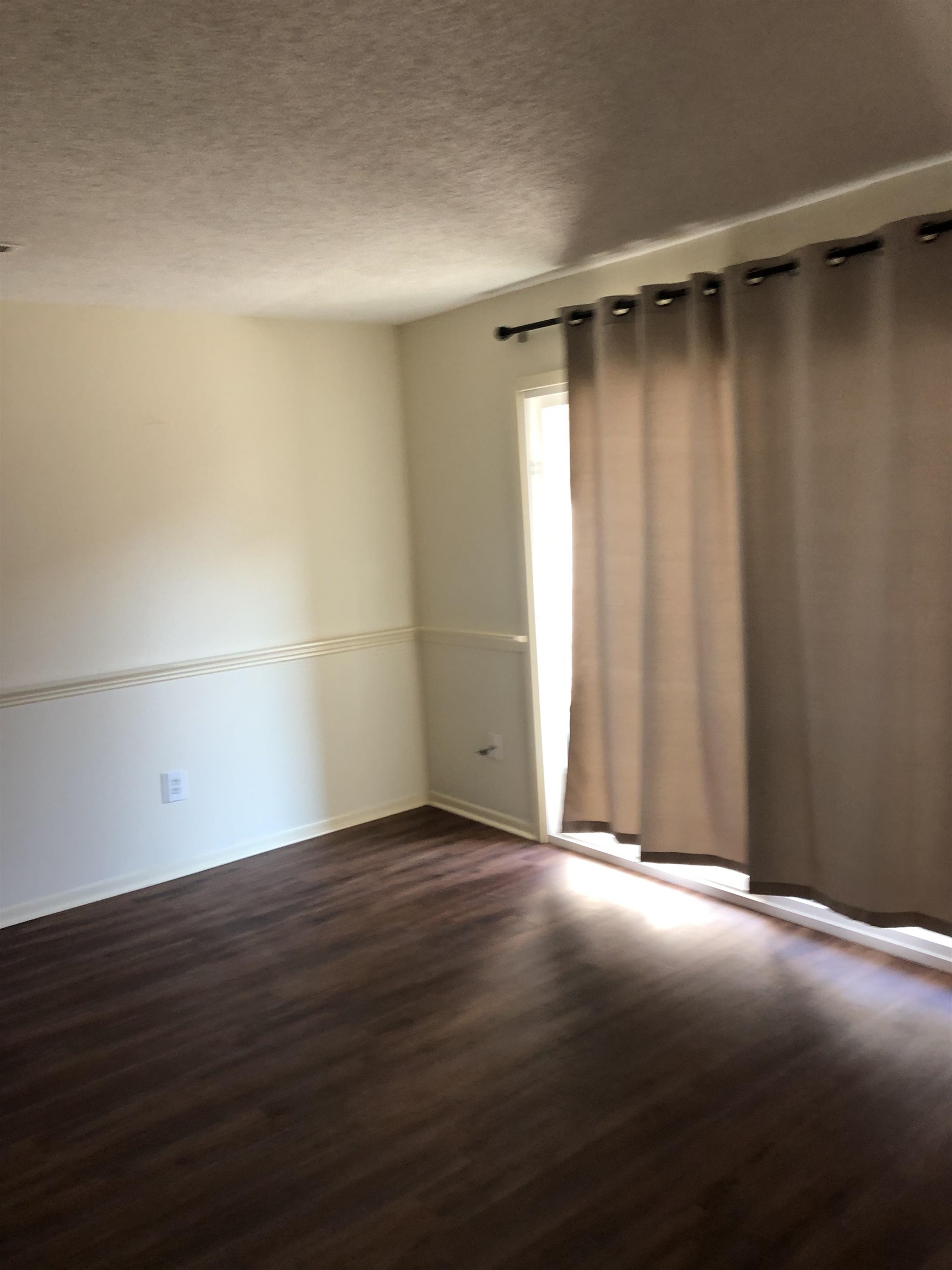 6784 Quail Hollow Court, Unit 2 Memphis, TN 38120 - Photo 4 of 4 a view of an empty room with wooden floor
