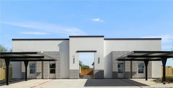 a front view of a building with parking space and windows