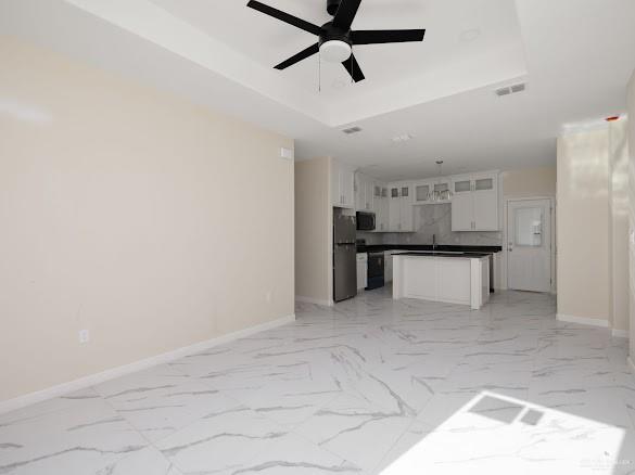 611 Mountain Road, Unit 5B Mission, TX 78573 - Photo 3 of 17 Open concept living space featuring large format marble-look tile flooring, a black ceiling fan, and recessed lighting