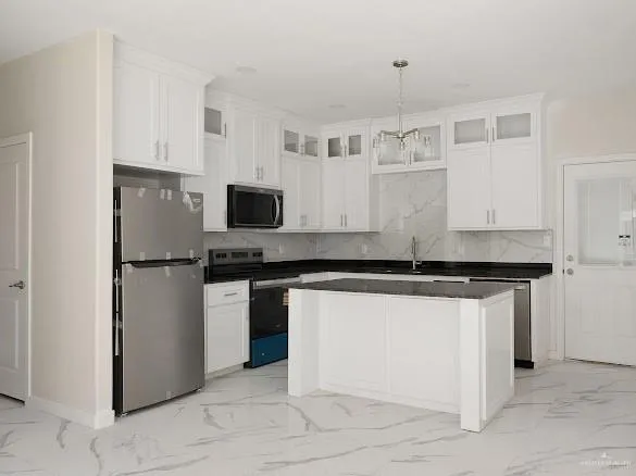 a kitchen with stainless steel appliances granite countertop a stove and a refrigerator