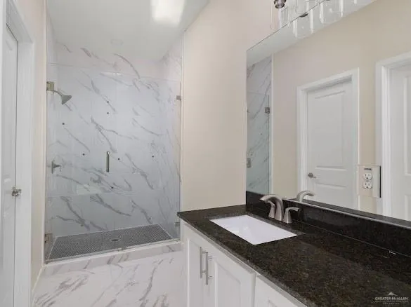 a bathroom with a granite countertop sink and a mirror