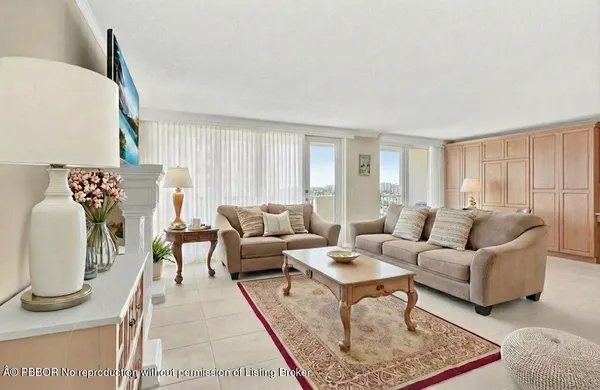a living room with furniture a rug and a window