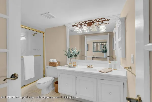 a bathroom with a sink mirror and toilet