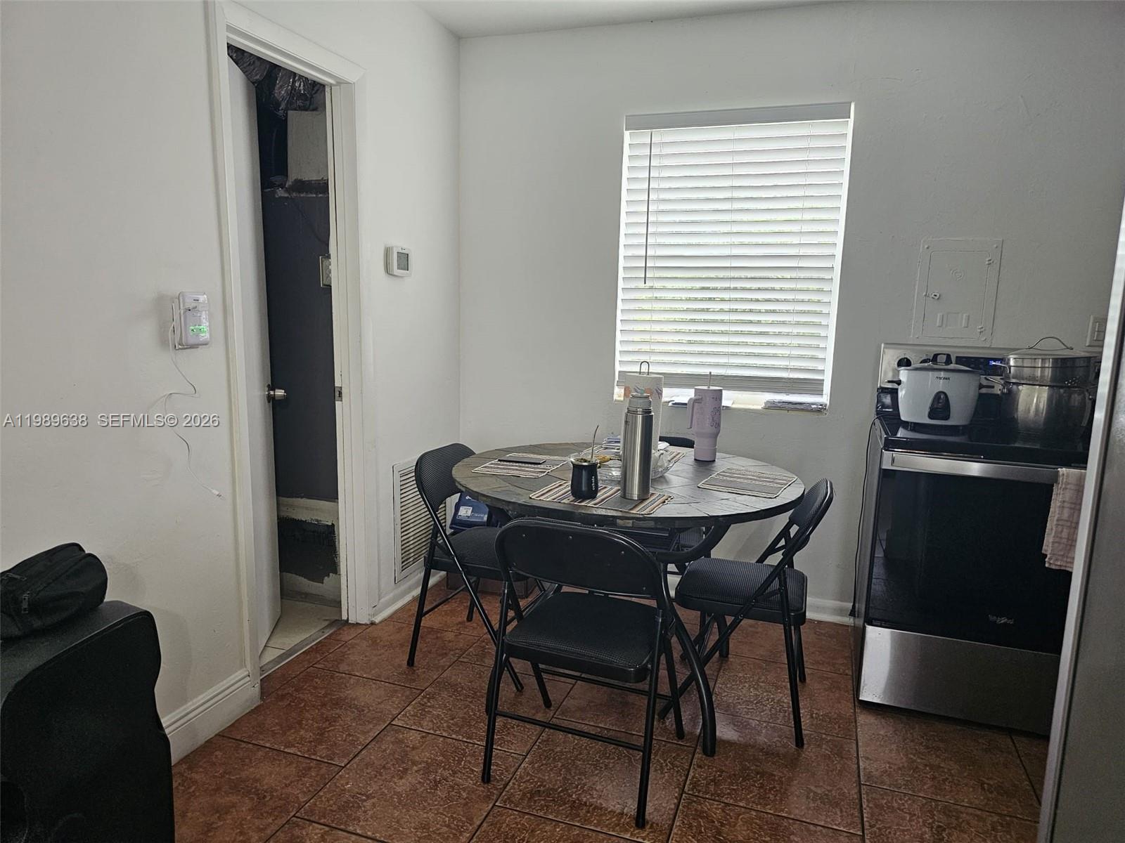569 Tallulah Road Lake Worth, FL 33462 - Photo 12 of 40 a dining room with furniture and window