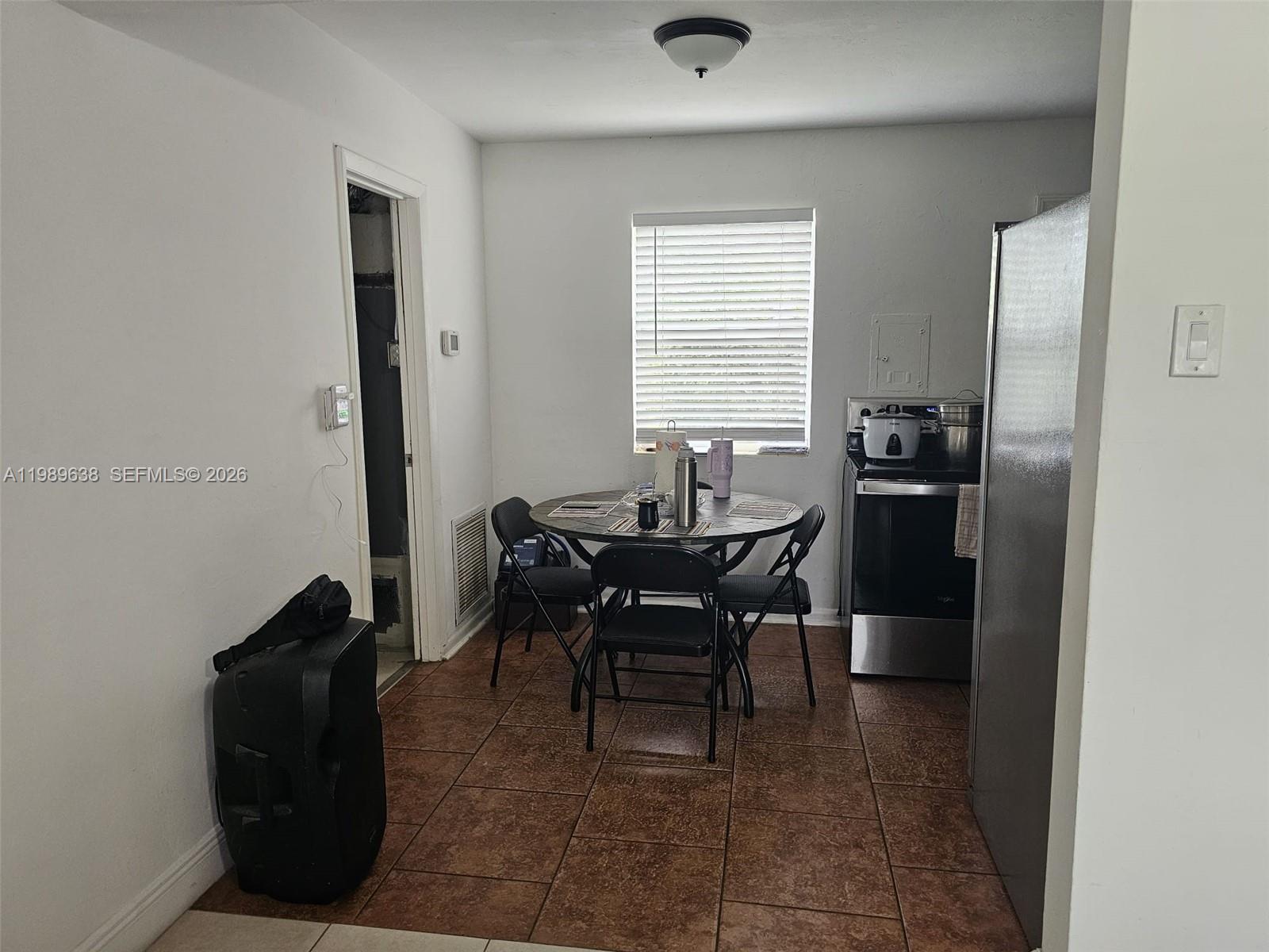 569 Tallulah Road Lake Worth, FL 33462 - Photo 13 of 40 a dining room with furniture and window