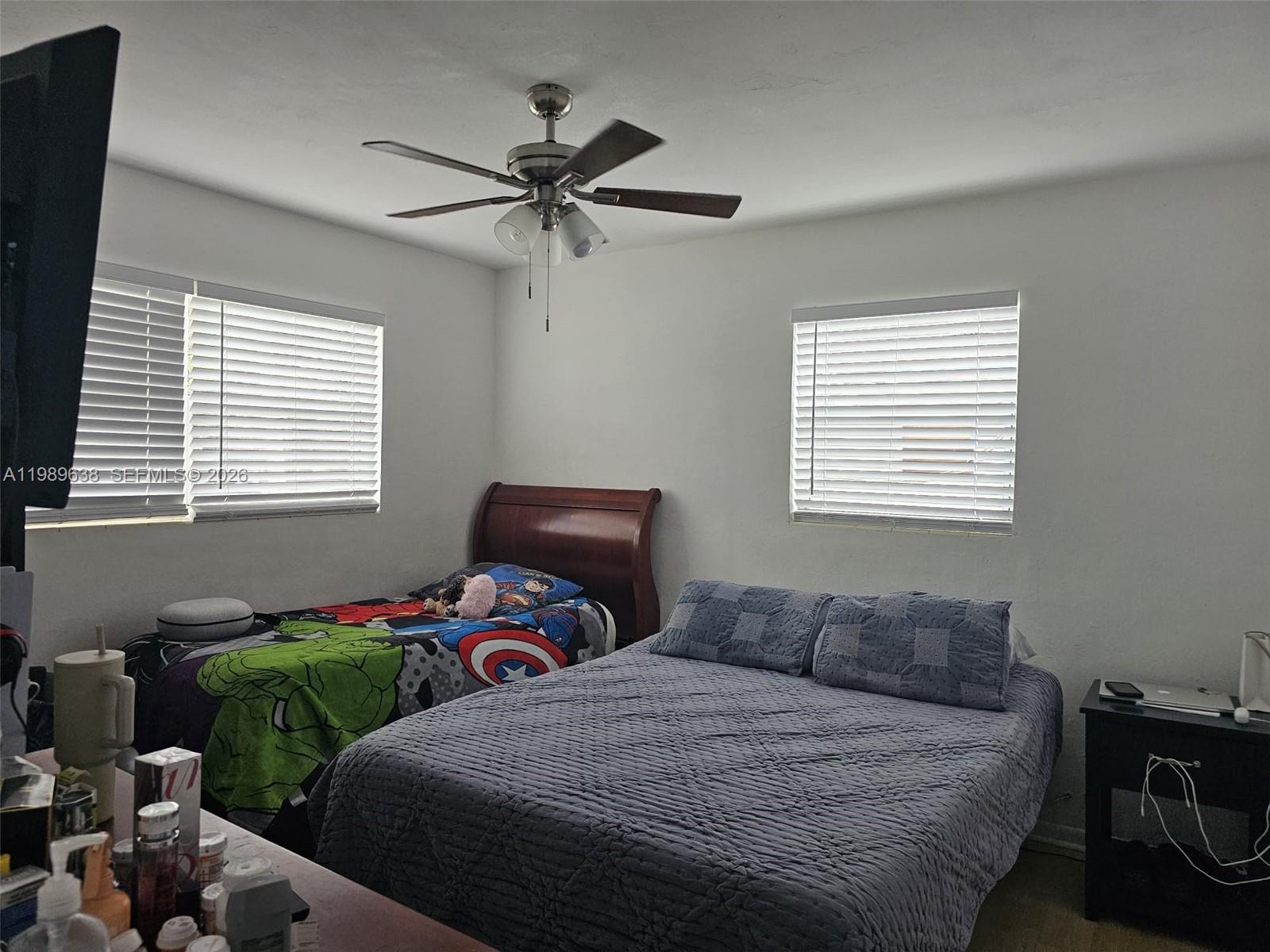 569 Tallulah Road Lake Worth, FL 33462 - Photo 15 of 40 a bedroom with a bed and a window