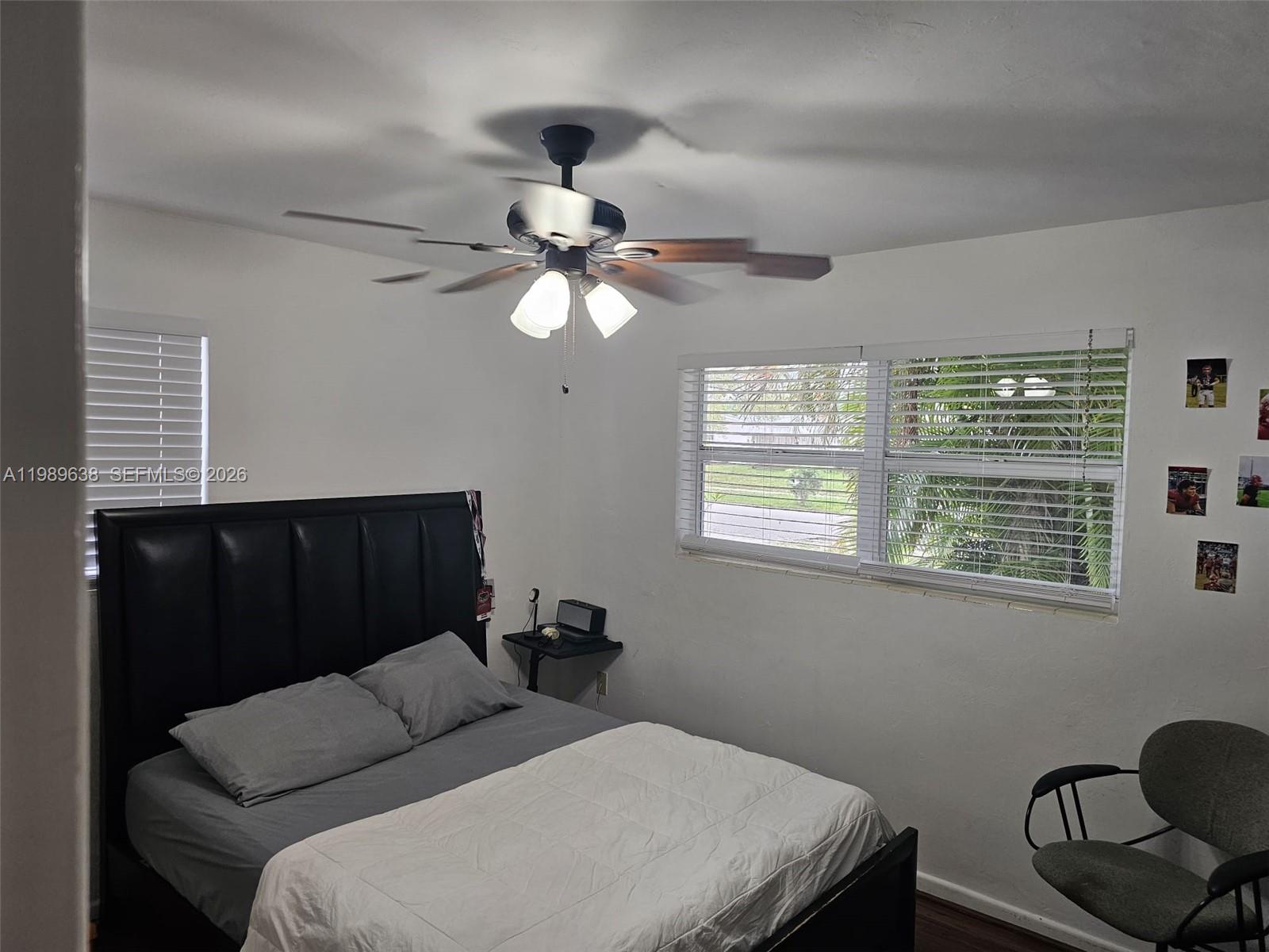 569 Tallulah Road Lake Worth, FL 33462 - Photo 17 of 40 a bedroom with a bed window and a chandelier