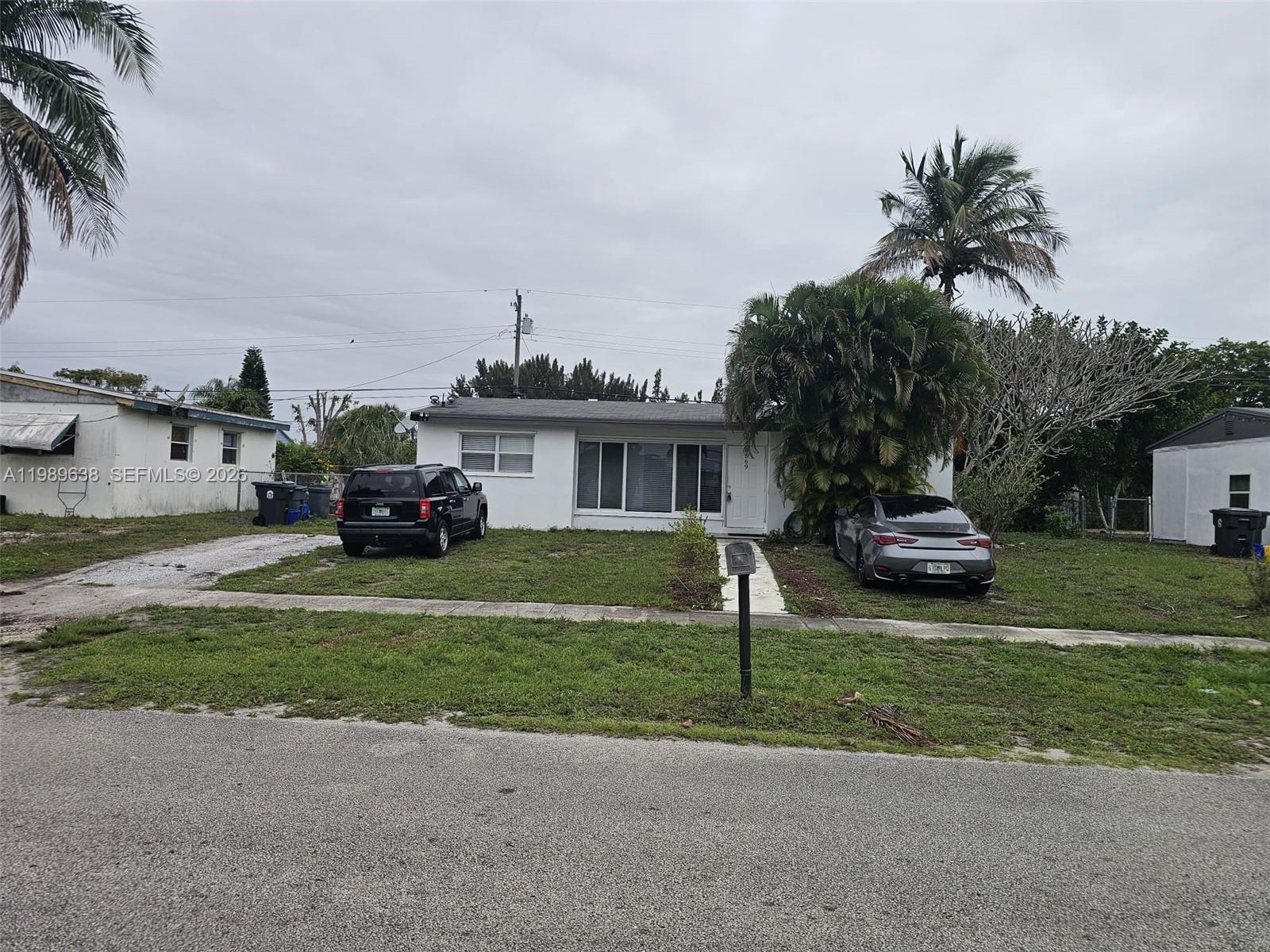 569 Tallulah Road Lake Worth, FL 33462 - Photo 2 of 40 a house view with a garden space