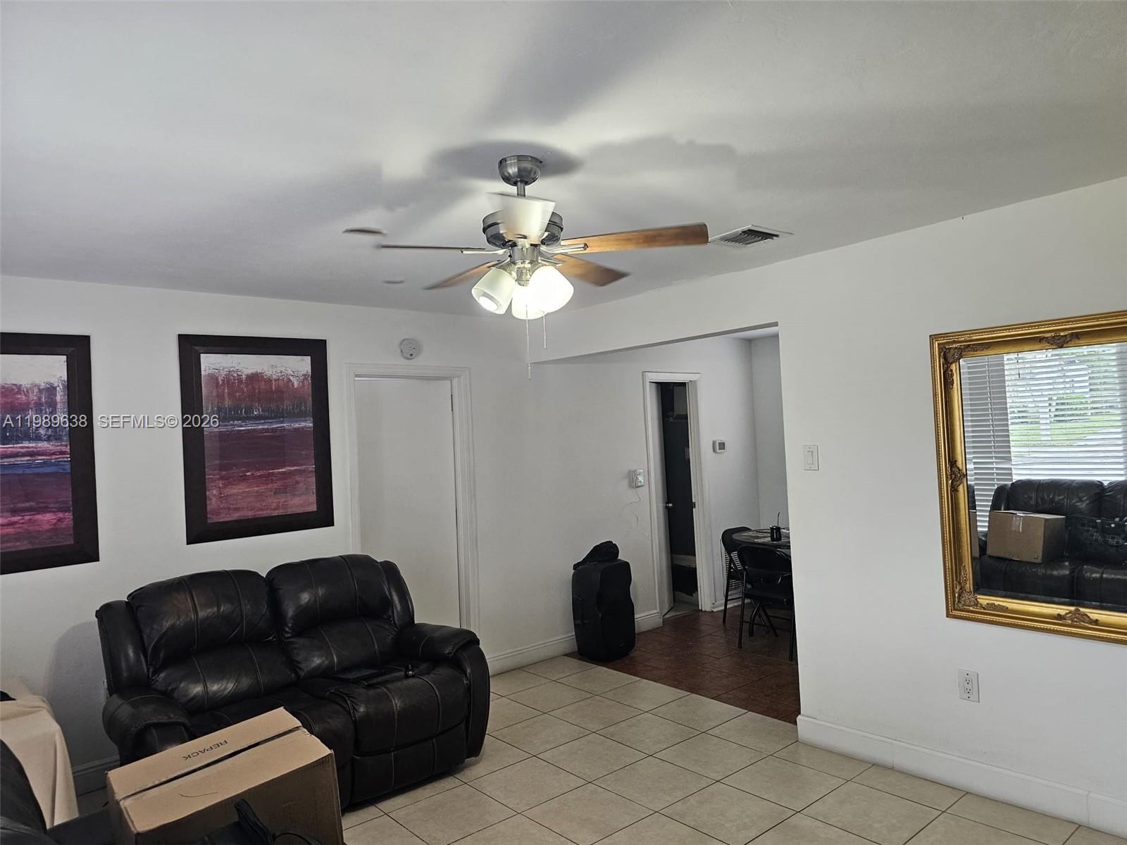 569 Tallulah Road Lake Worth, FL 33462 - Photo 24 of 40 a living room with couches and a dining table with bookshelf