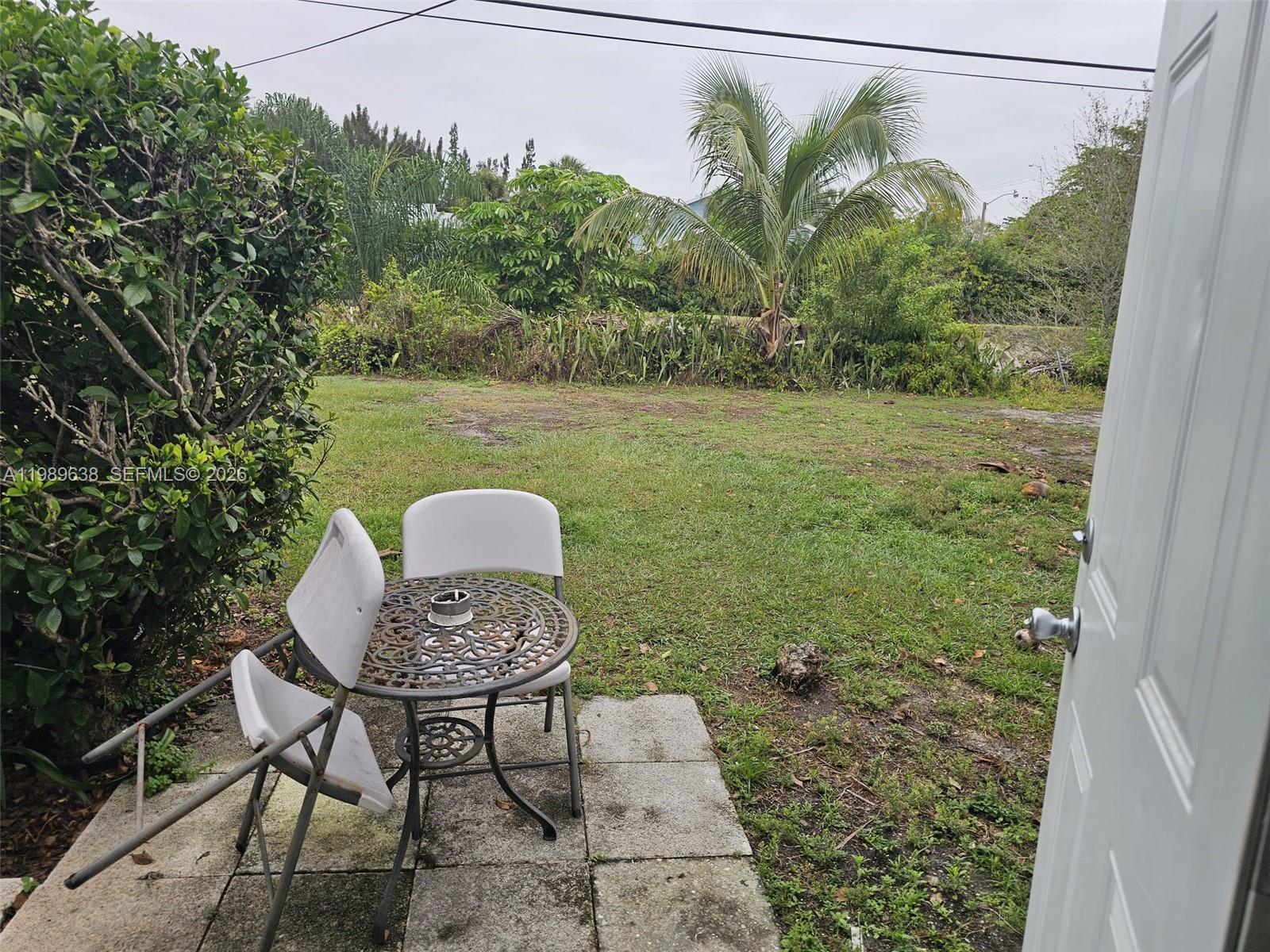 569 Tallulah Road Lake Worth, FL 33462 - Photo 29 of 40 a view of a chairs and table in patio